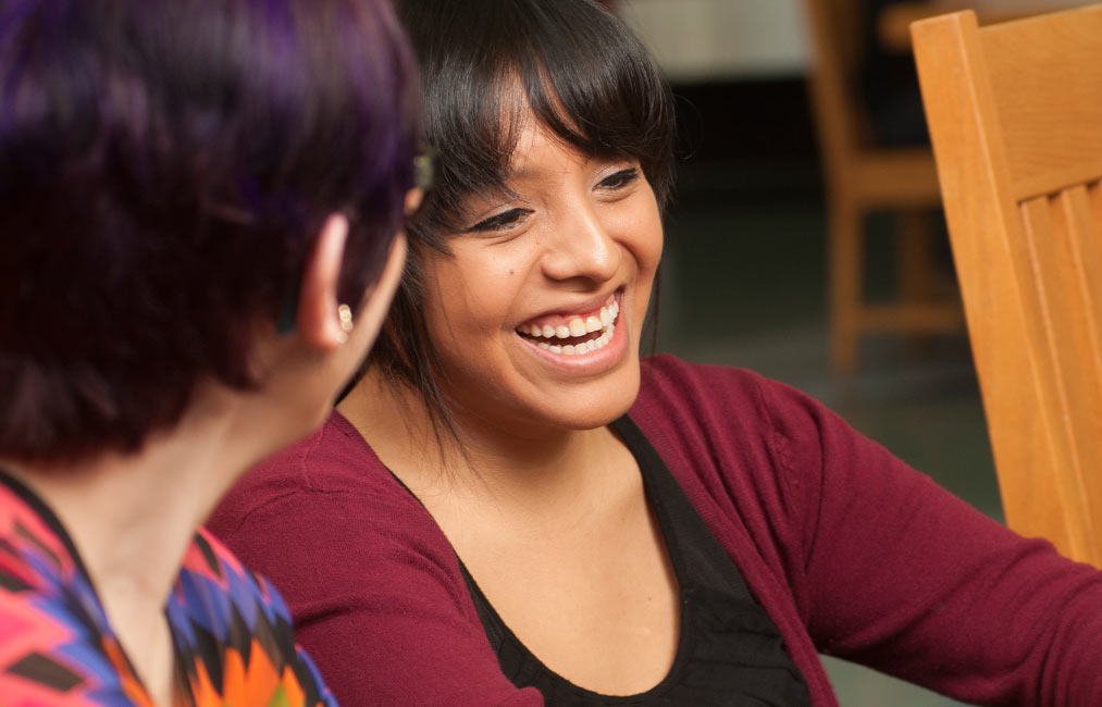 Raquel Ramirez helps a student in the UC Davis library.